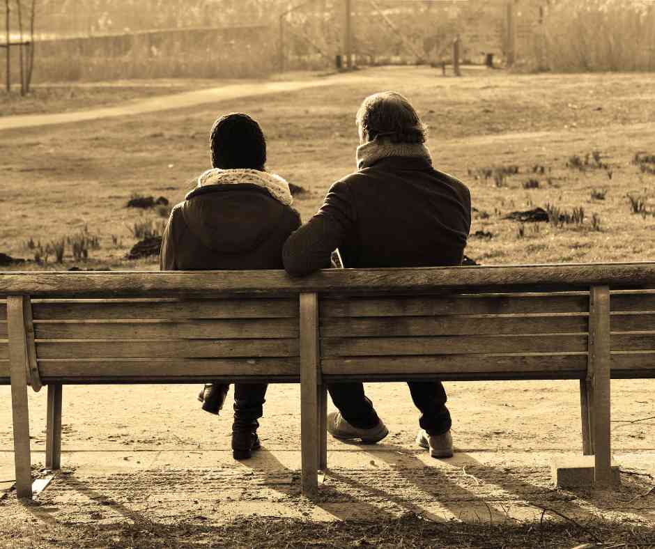 couple sitting on an outdoor bench navigating pornography as a couple