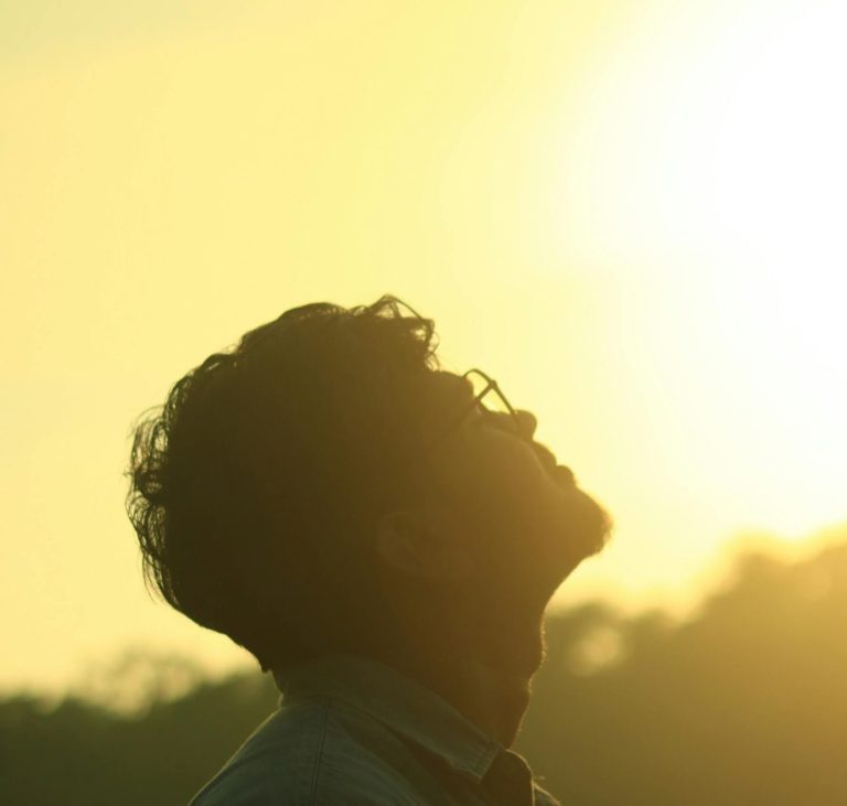 Guy looking up at sunset How to recover from a porn addiction